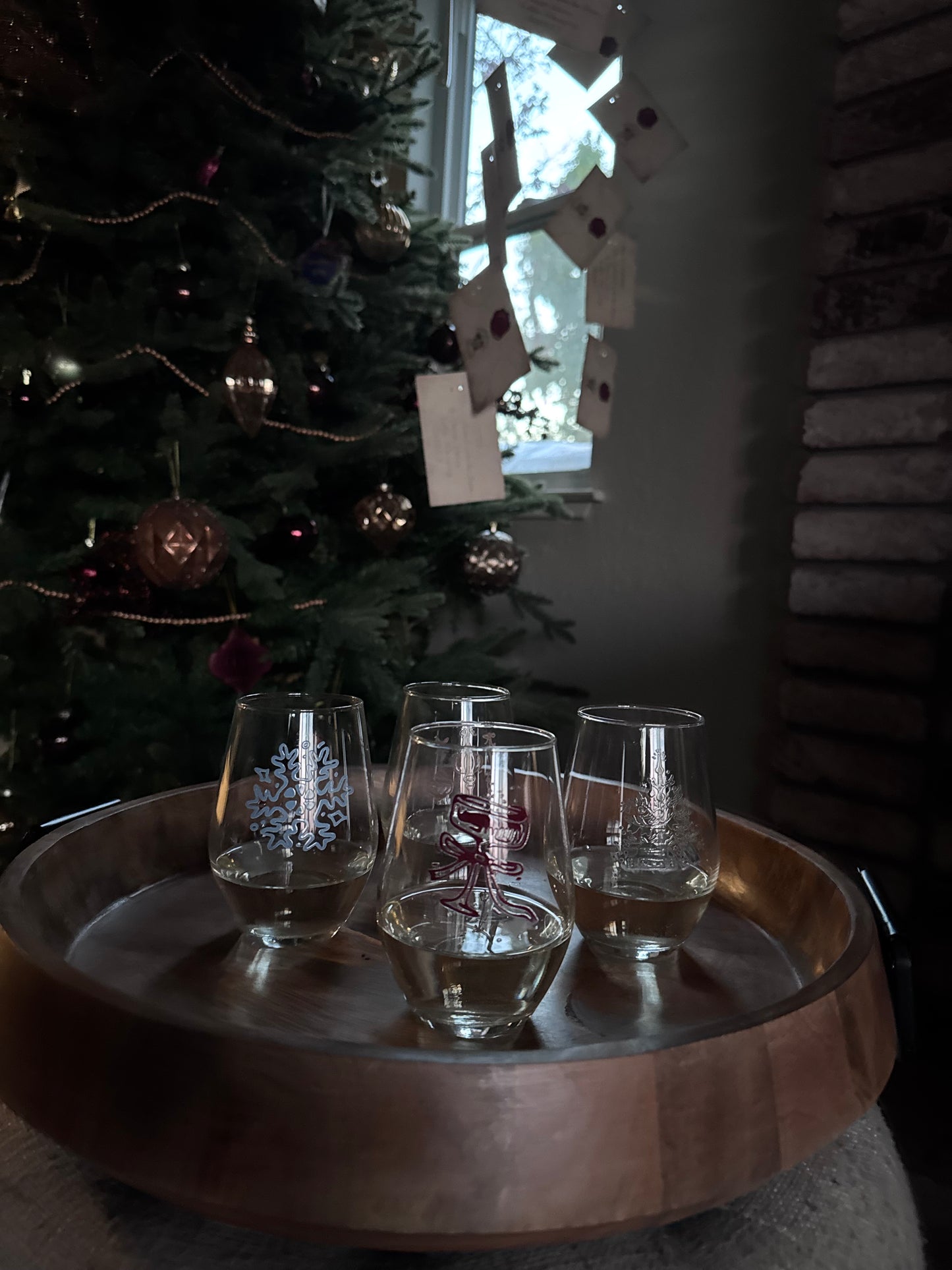 Christmas tree with wine glasses in the foreground