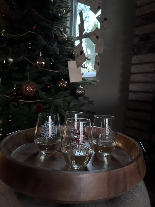Christmas tree with wine glasses in the foreground