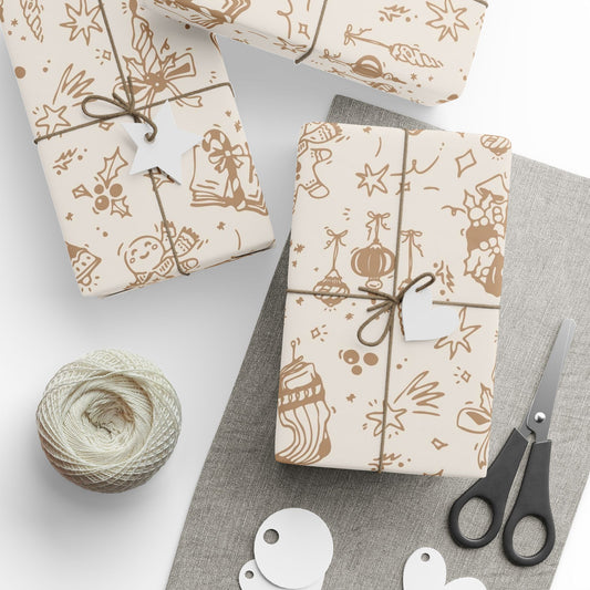 Gift wrapping paper with festive designs, scissors, and yarn on a white surface