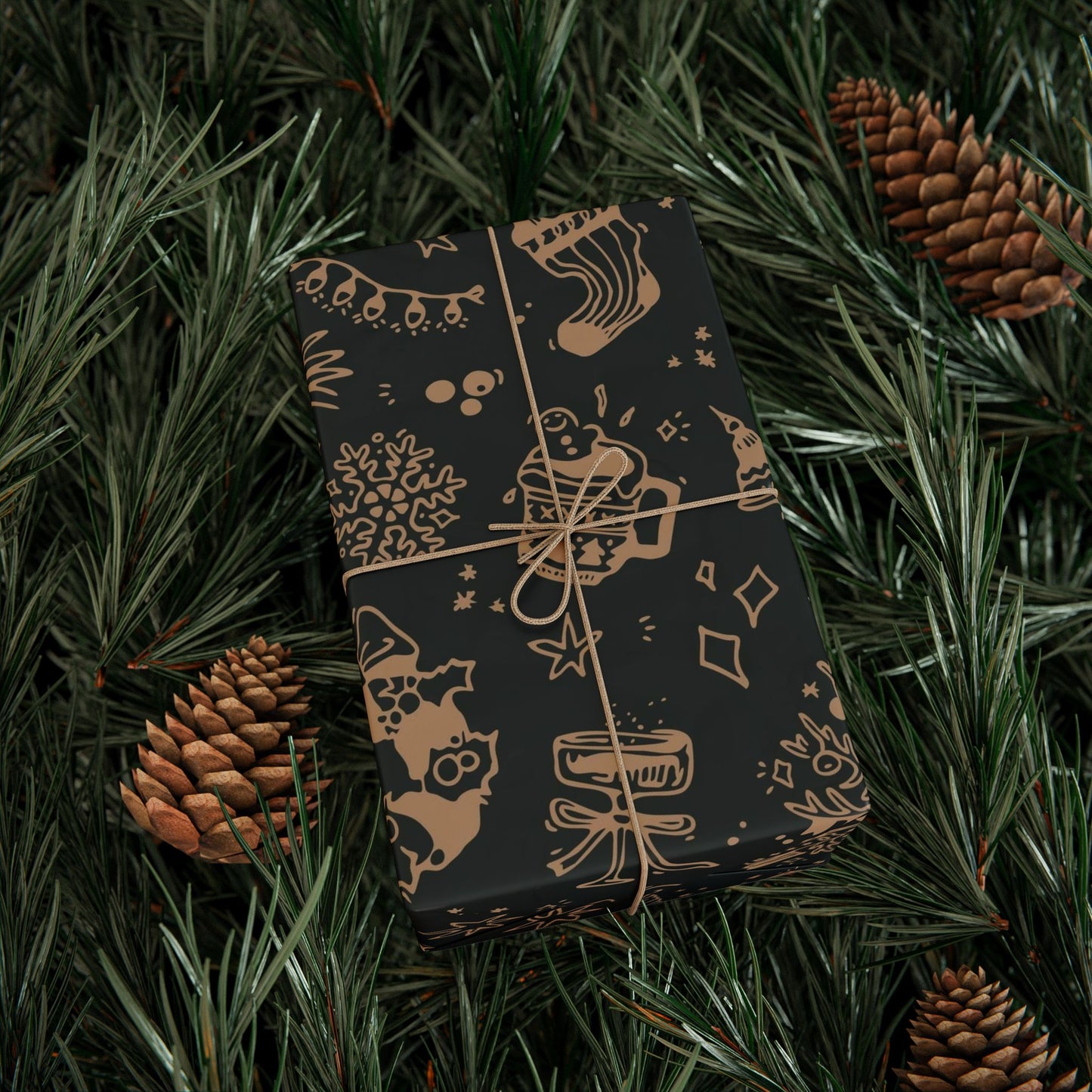 Darkly wrapped gift with festive patterns on a bed of pine needles and pine cones.