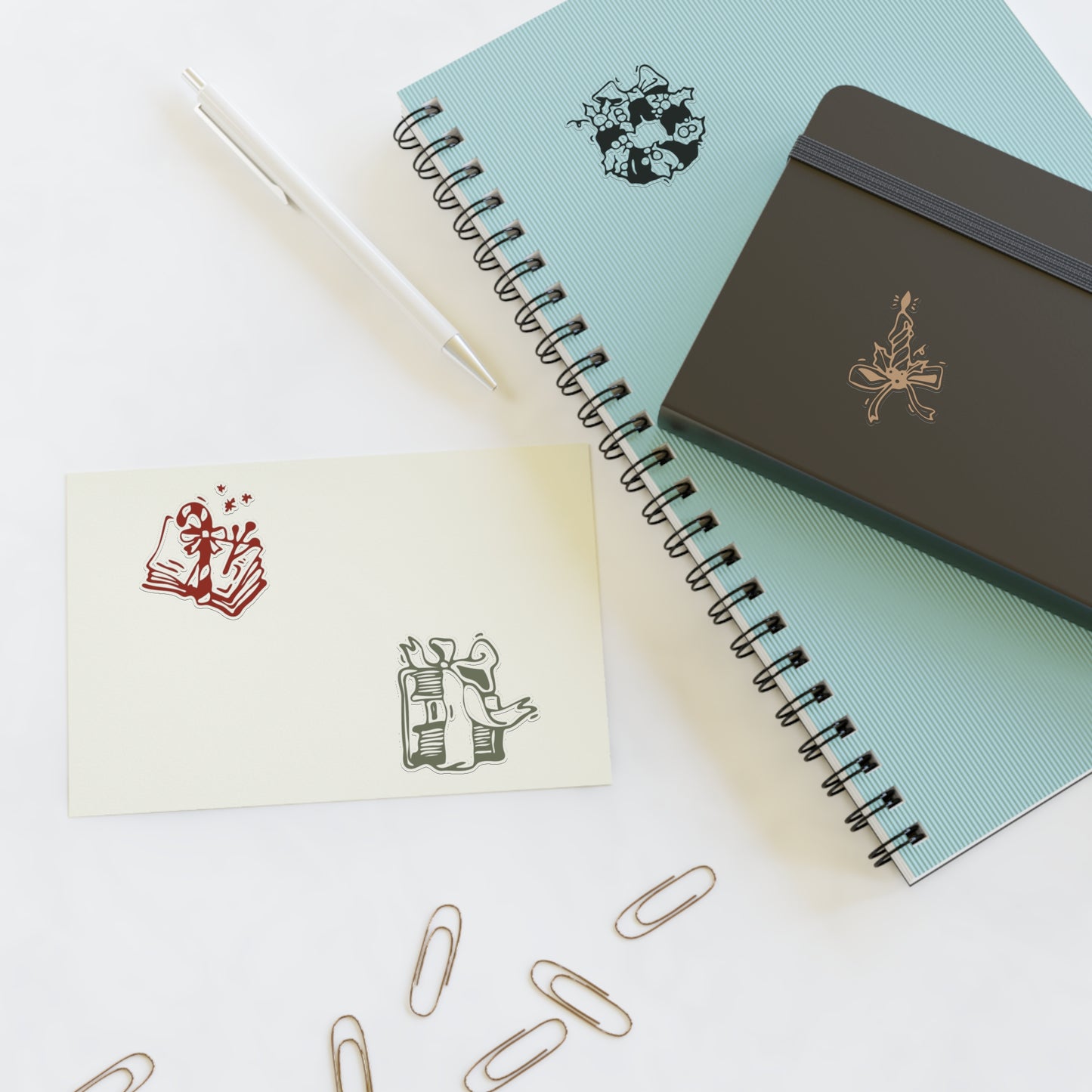 Notebooks with decorative elements on a white surface