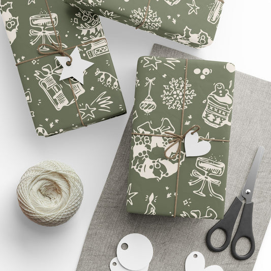 Gift boxes wrapped in green paper with white patterns, scissors, and yarn on a gray surface.