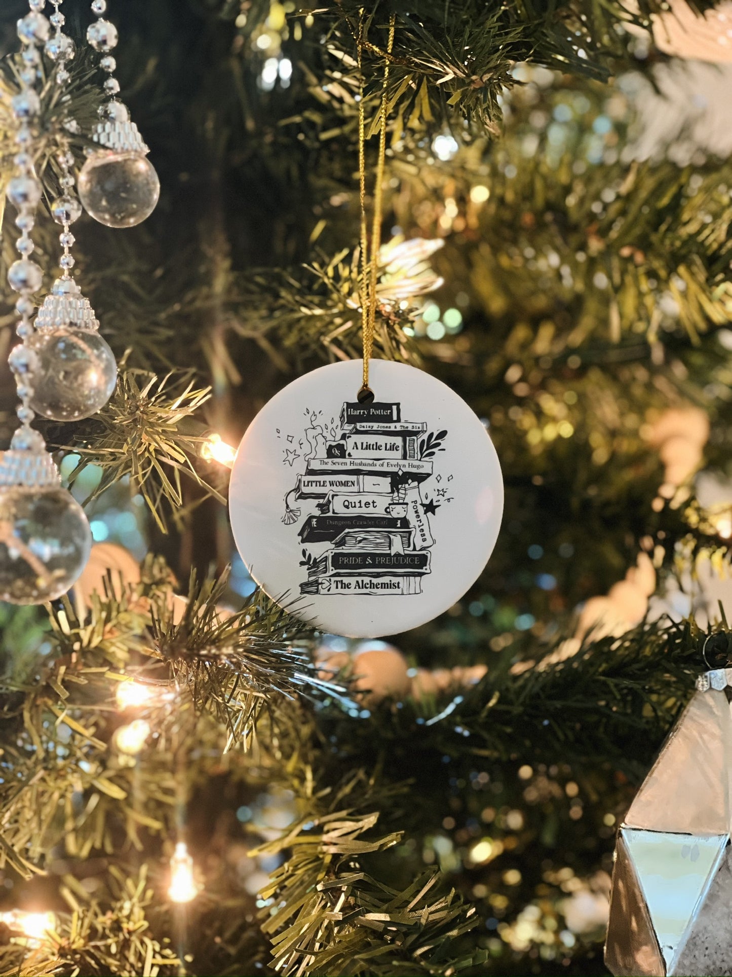 Decorative ornament with text hanging on a Christmas tree