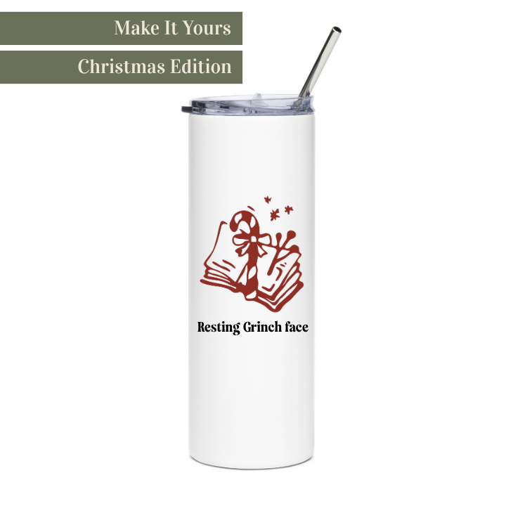 White tumbler with red candy cane and book design and straw on a white background