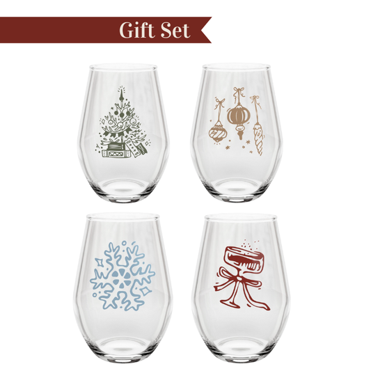 Set of four stemless wine glasses with decorative designs on a white background