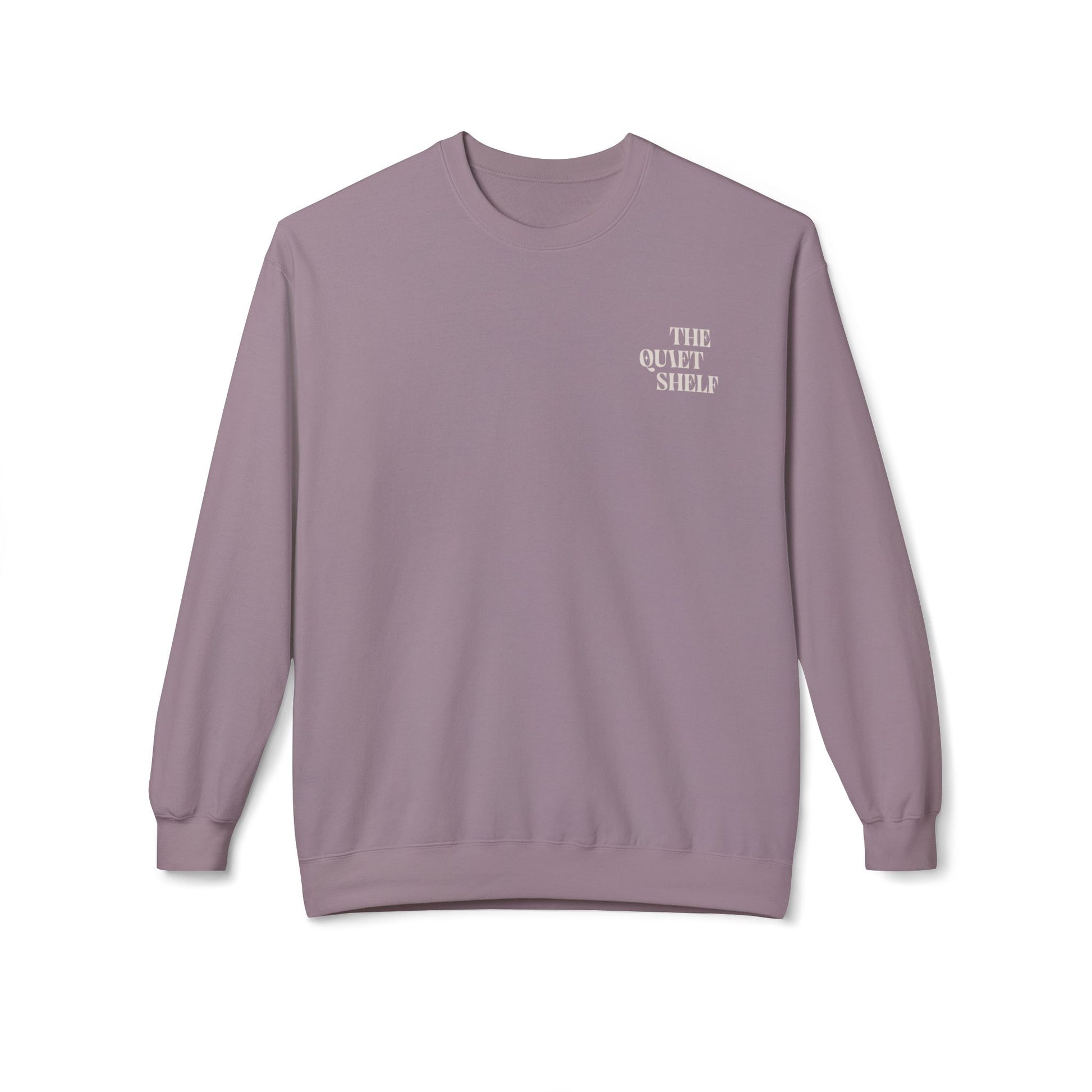 A purple crewneck sweatshirt with 'THE QUIET SHELF' written in a small, bold font on the upper left front side.