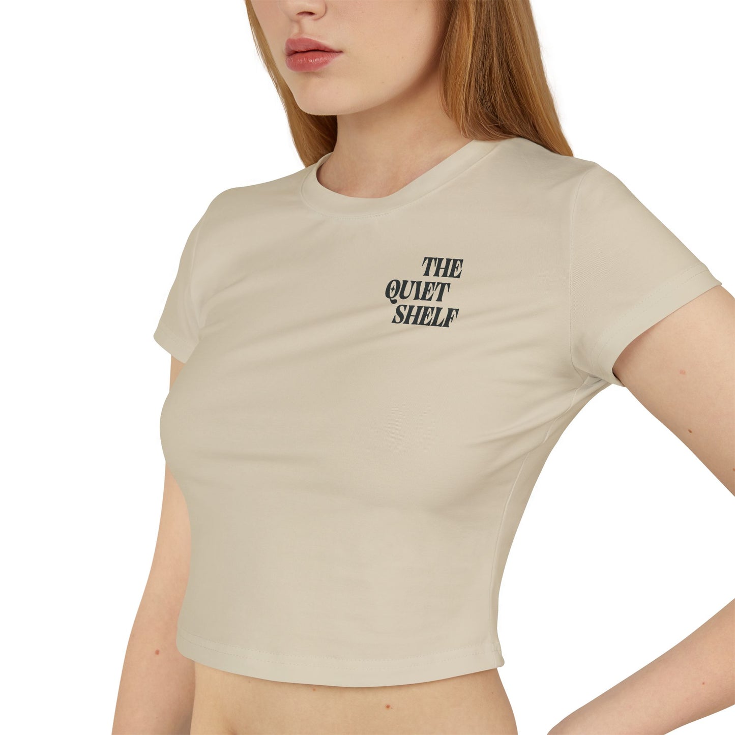 Beige t-shirt with 'The Quiet Shelf' text worn by a person on a white background