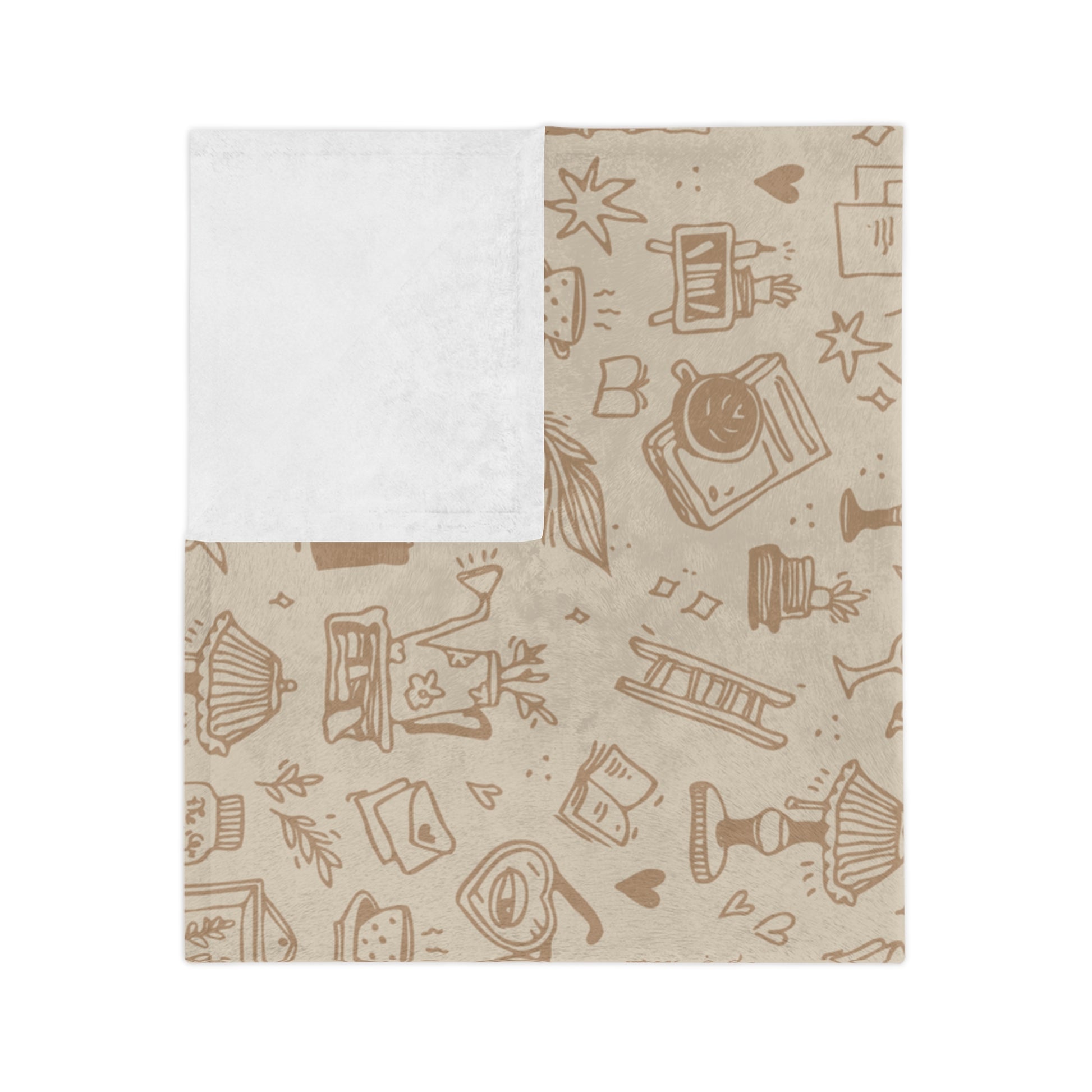 A blanket with a subtle pattern featuring book-related imagery, such as books, envelopes, and coffee cups, on a beige background.
