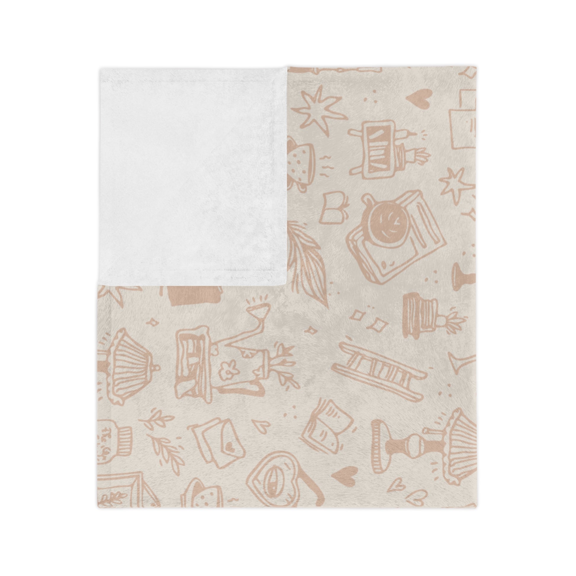 A blanket with a subtle pattern featuring book-related imagery on a light background.