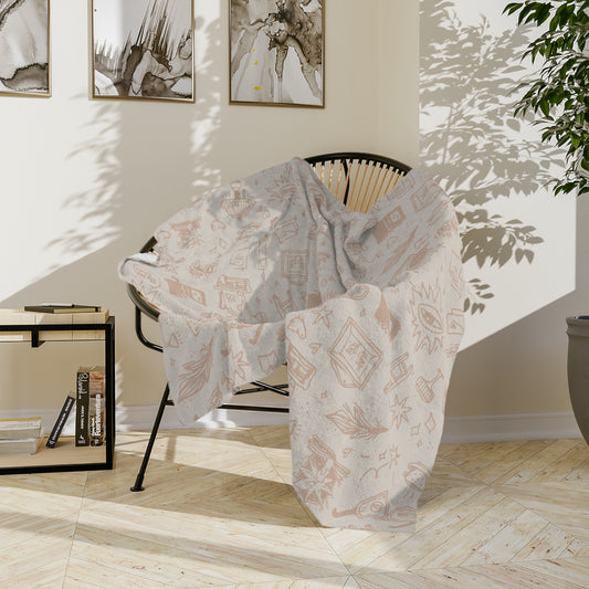 Decorative blanket draped over a chair in a room with light-colored walls and a plant.