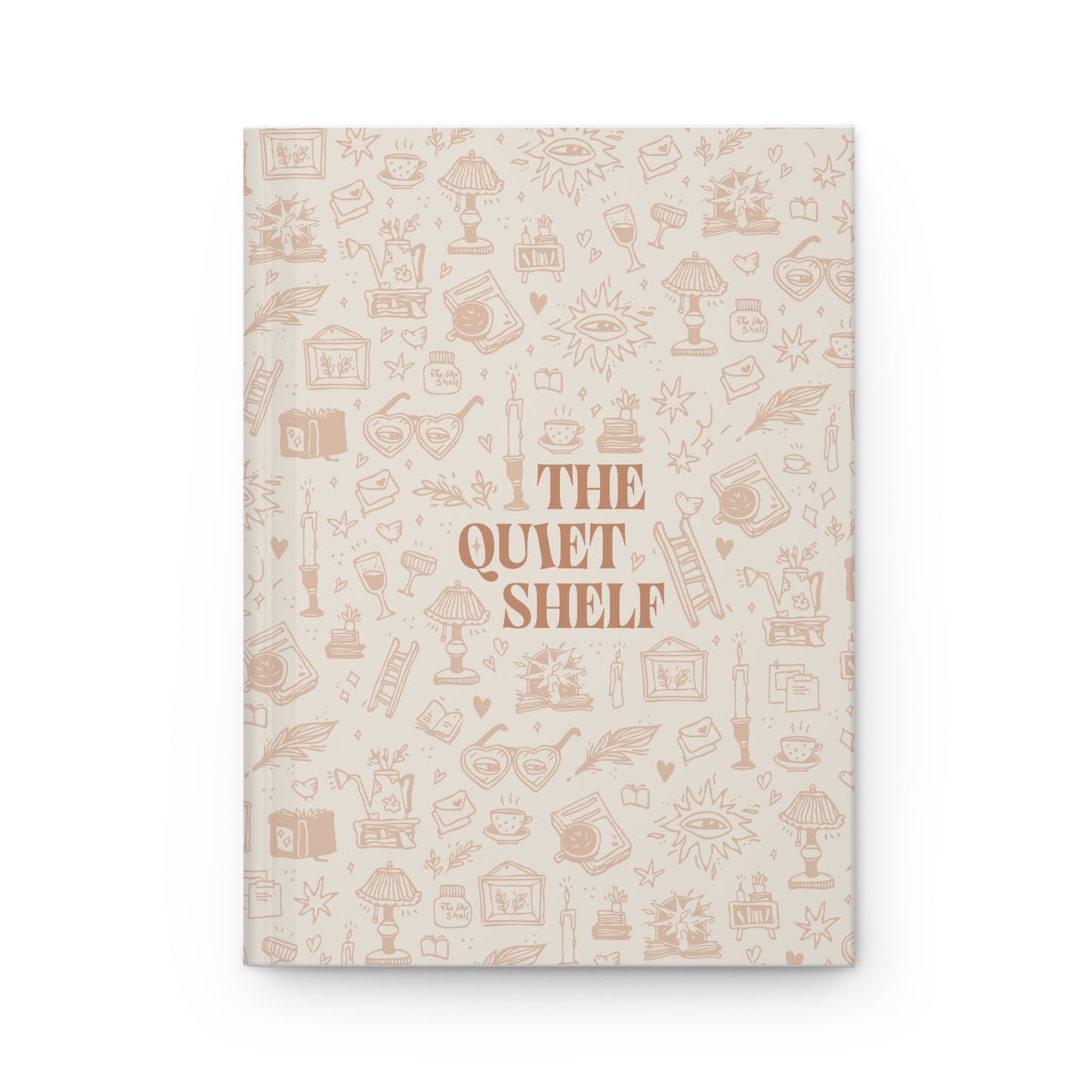 A beige hardcover journal with a pattern of book-related illustrations and the title 'THE QUIET SHELF' printed on the cover.