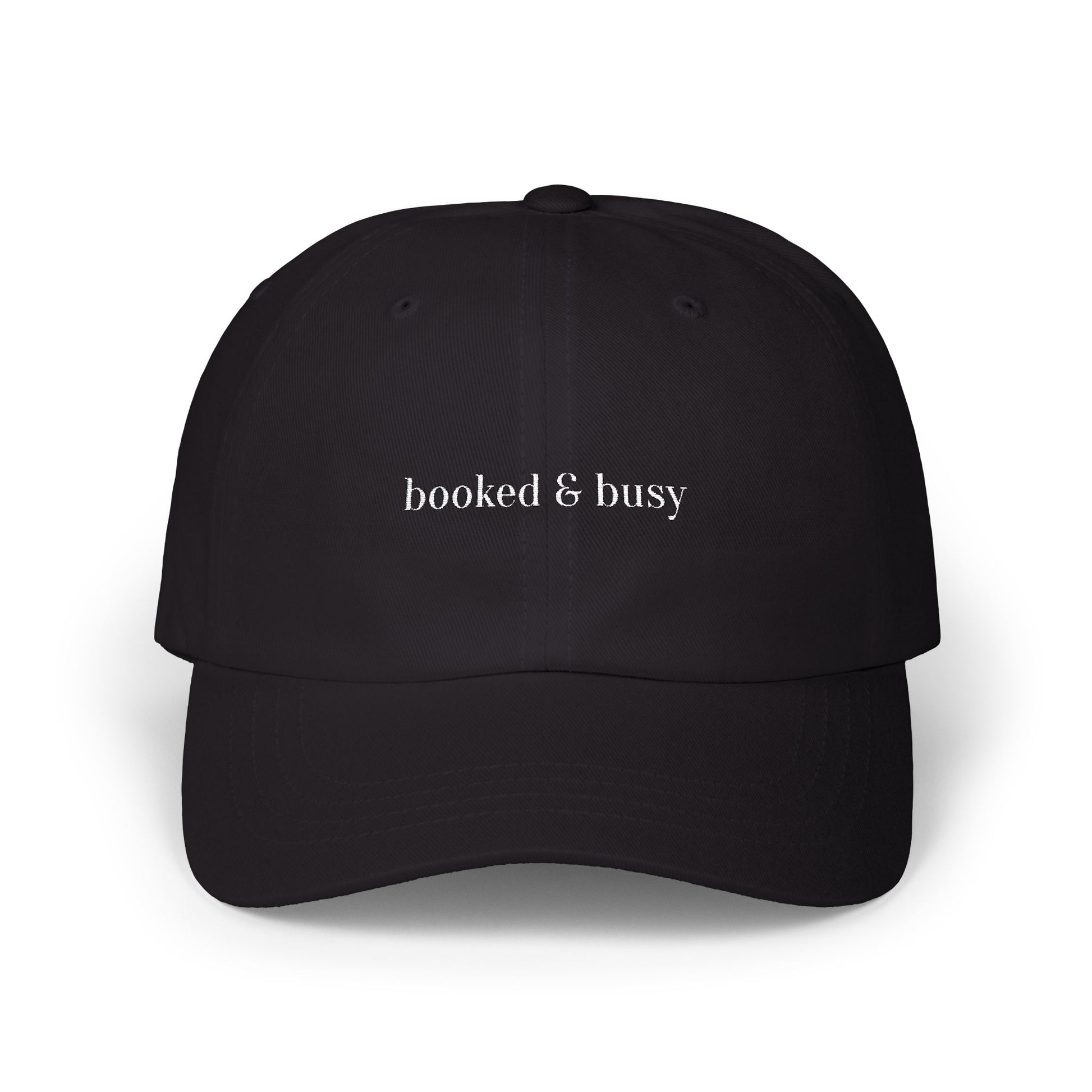 Black cap with 'booked & busy' text on a white background
