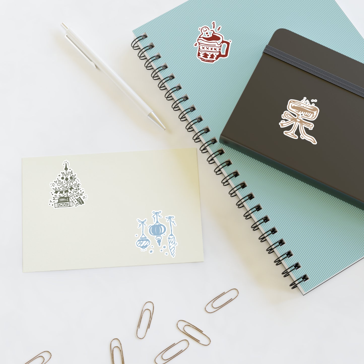 Notebooks with stickers and paper clips on a white background