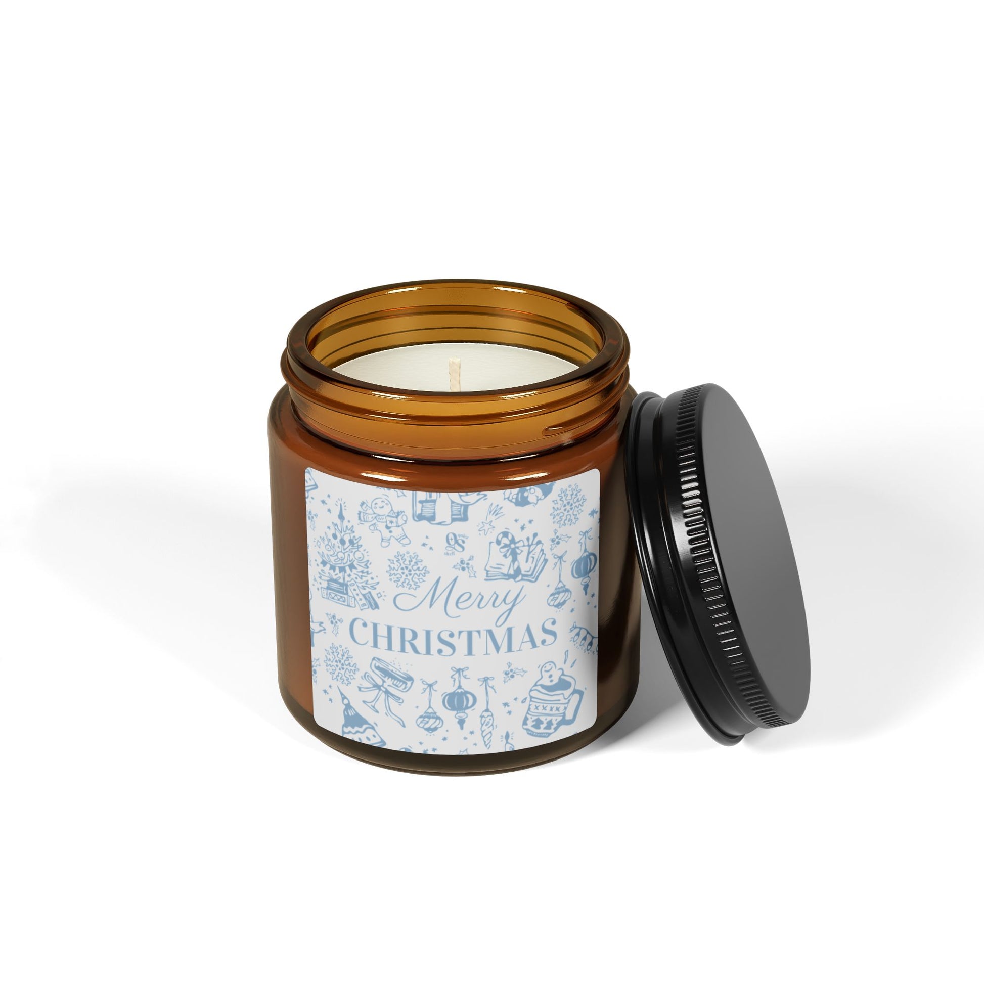 Brown jar candle with a Christmas-themed label on a white background