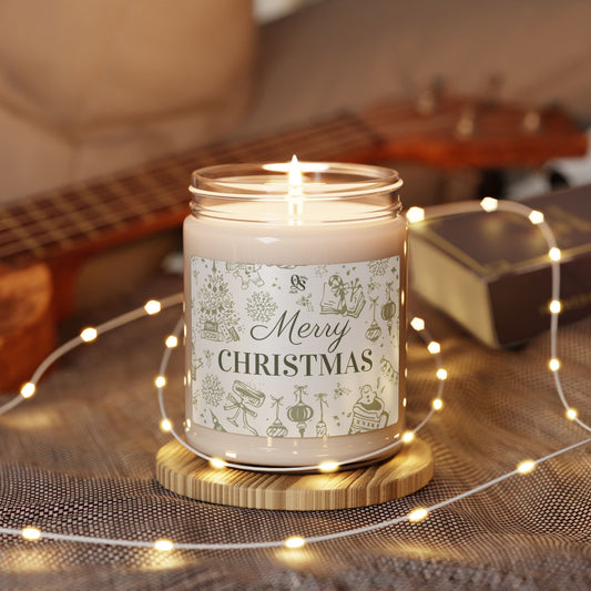 Lit candle with a 'Merry Christmas' label on a wooden coaster, surrounded by string lights and a guitar in the background.
