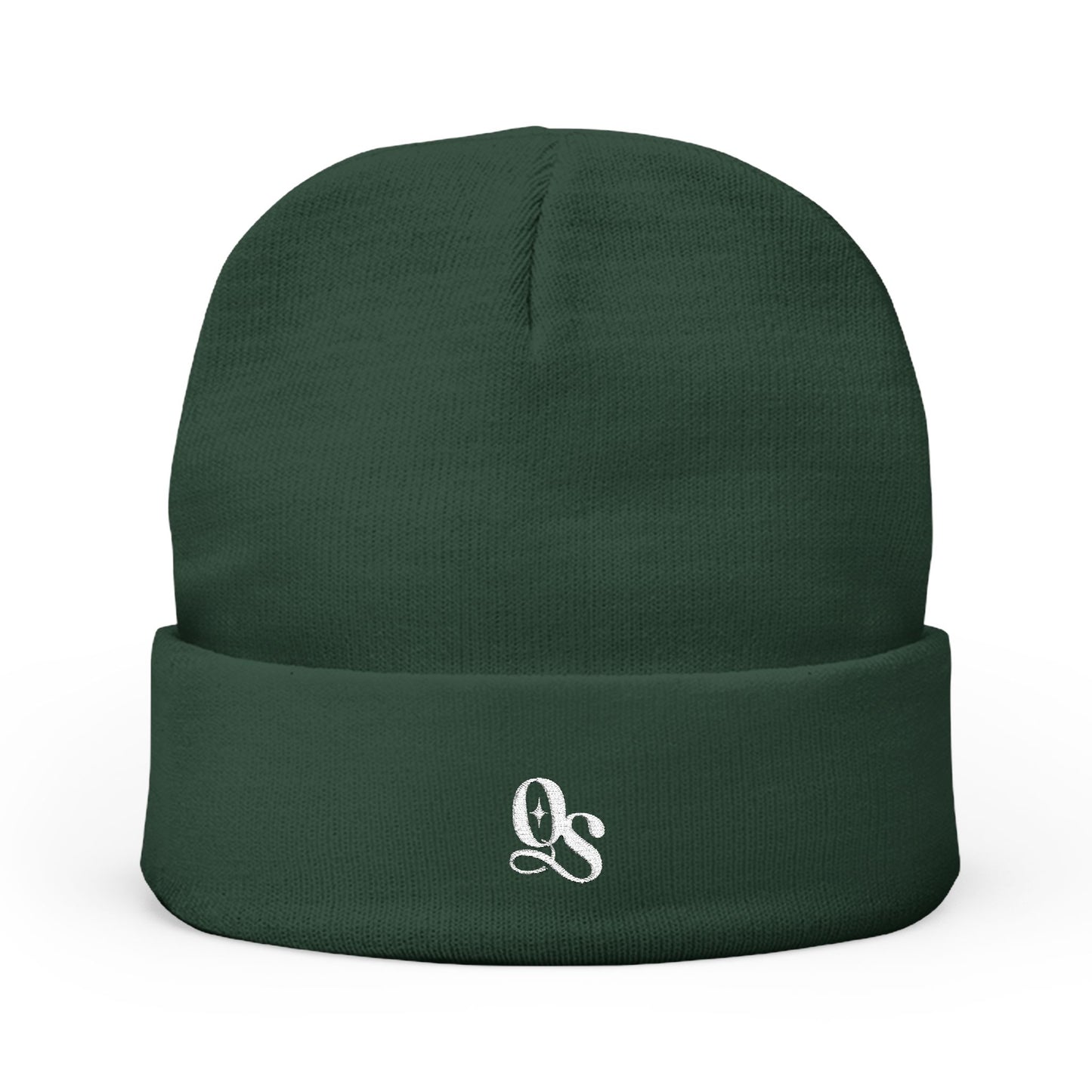 A green cuffed beanie with The Quiet Shelf's 'QS' monogram in embroidery on the front.