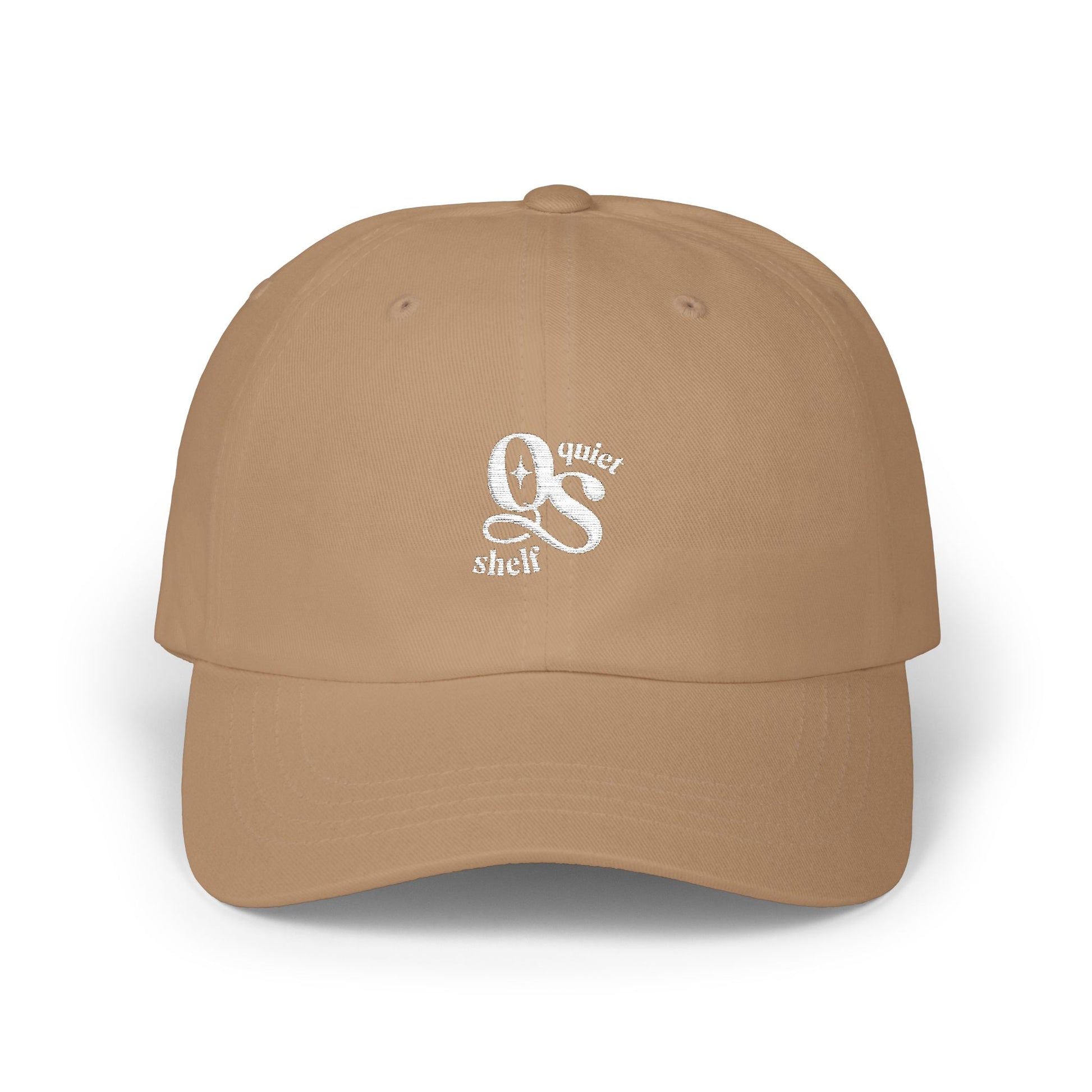 A brown dad hat with the Quiet Shelf's 'QS' logo embroidered in white on the front.