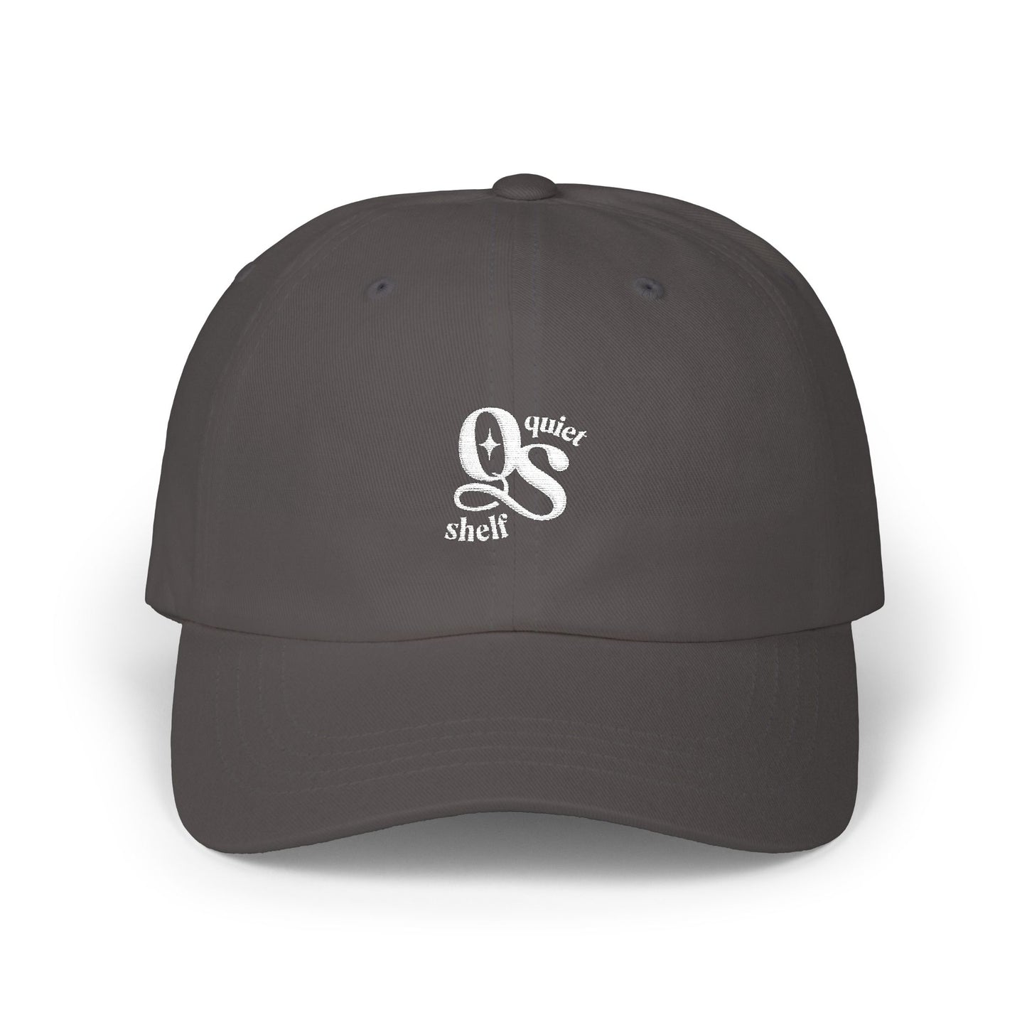 A dark dad hat with the Quiet Shelf's 'QS' logo embroidered in white on the front.