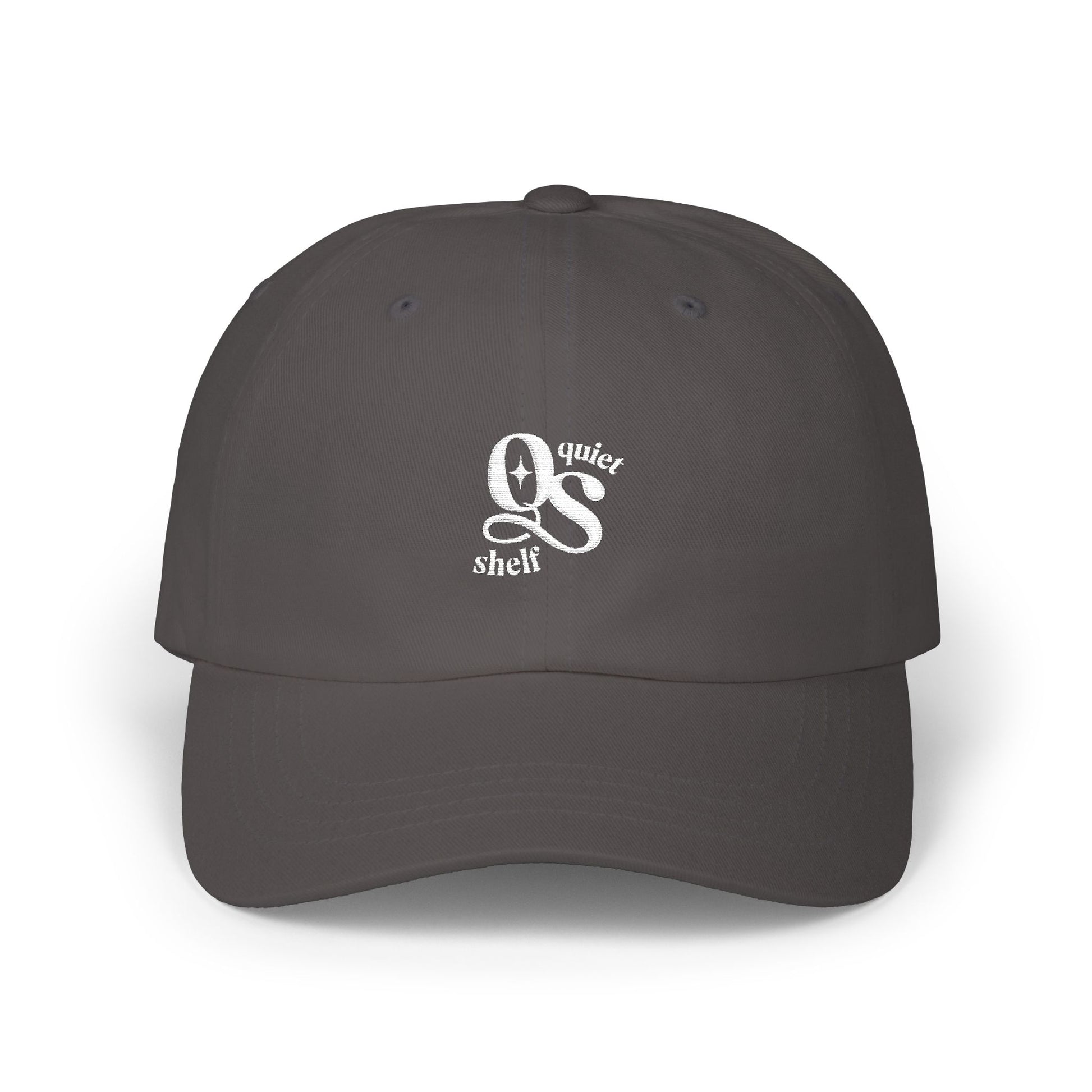 A dark dad hat with the Quiet Shelf's 'QS' logo embroidered in white on the front.