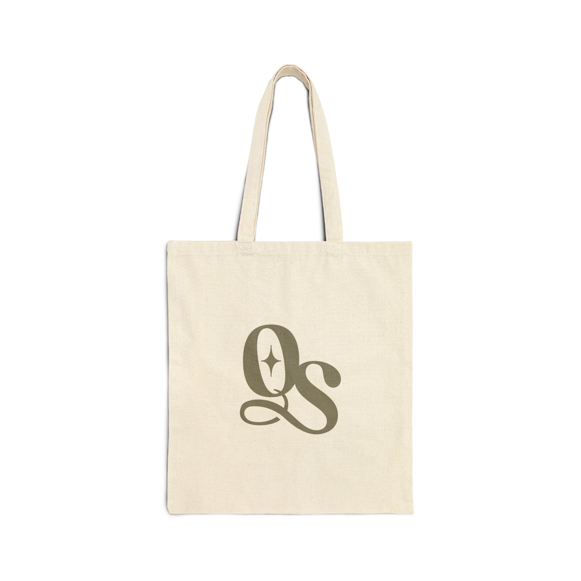 A beige cotton canvas tote bag with The Quiet Shelf's 'QS' monogram logo printed in the center.
