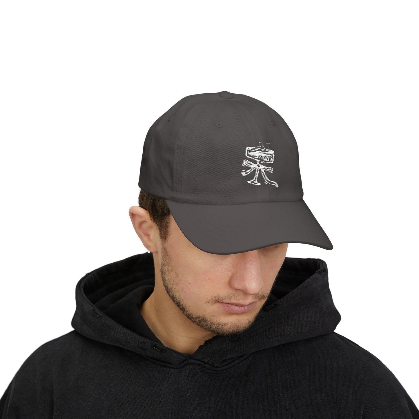 Person wearing a dark gray cap with a logo on a white background