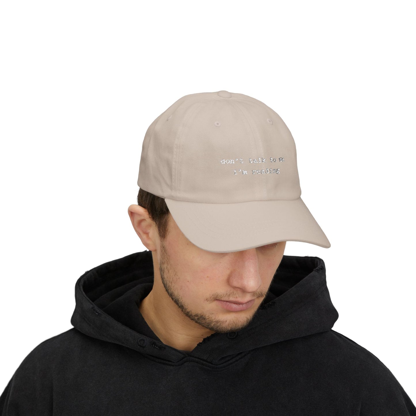 Man wearing a beige cap with text on a white background
