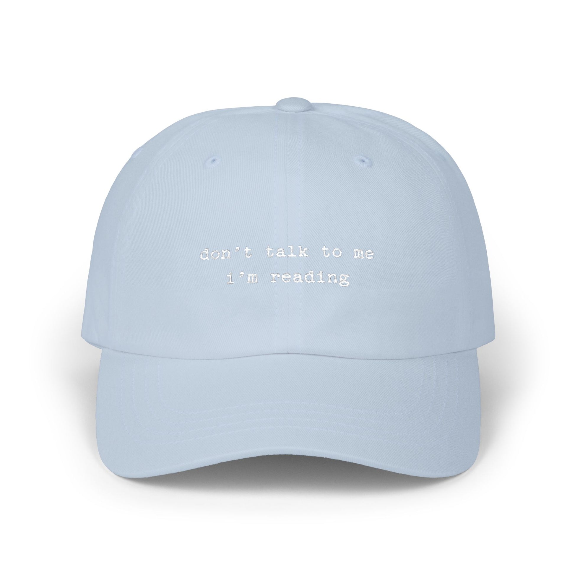 Light blue cap with text 'don't talk to me I'm reading' on a white background