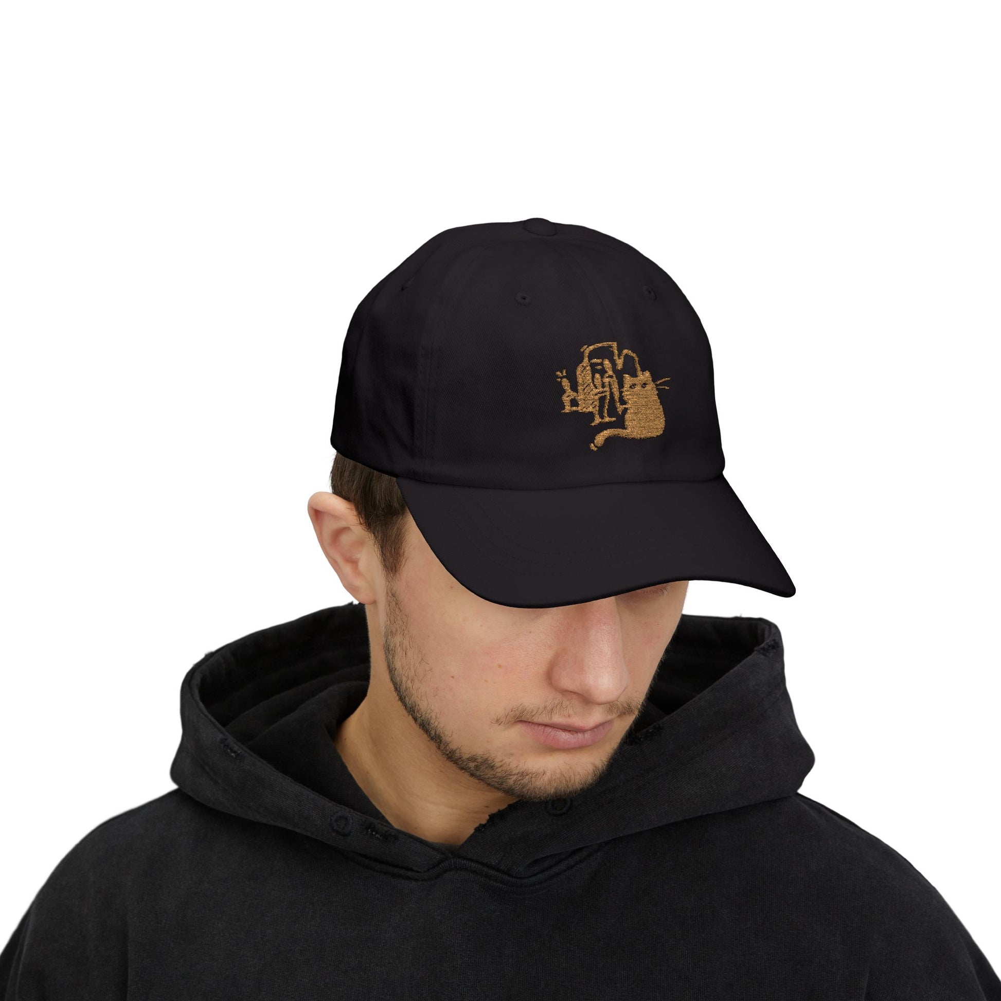 Person wearing a black cap with a logo and black hoodie on a white background