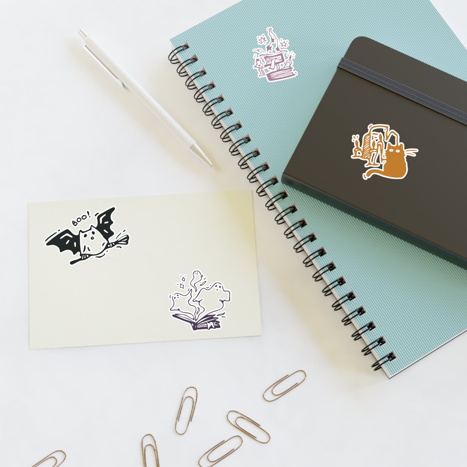 Notebooks with stickers on a white surface
