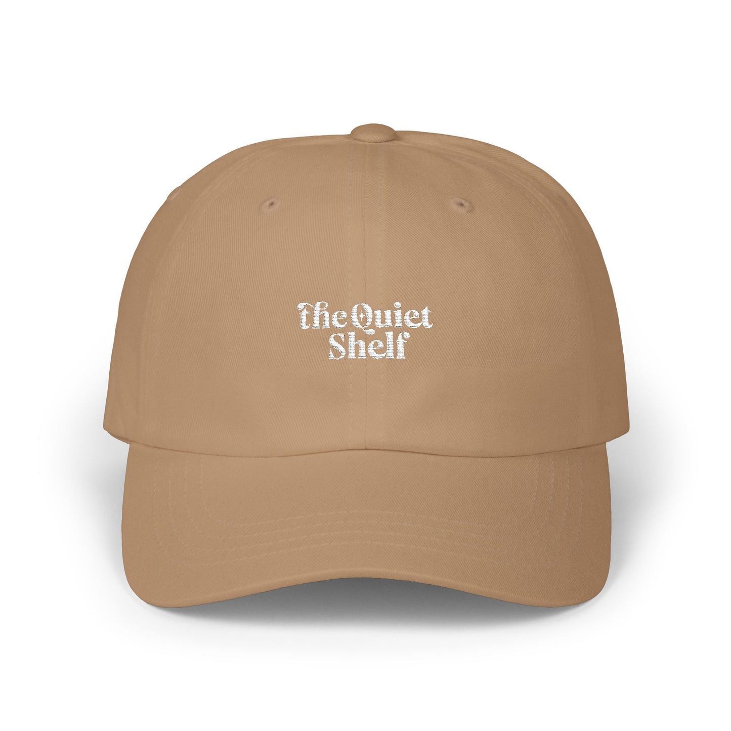 A beige dad hat with 'The Quiet Shelf' logo embroidered in the center.