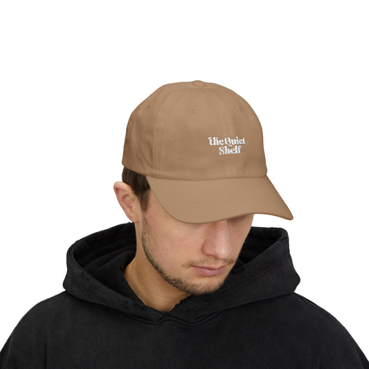 Man wearing a brown cap with 'The Quiet Life' logo on a white background