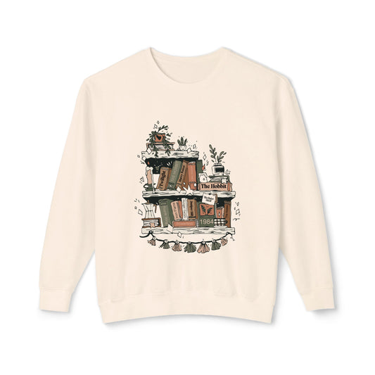 Beige sweatshirt with a graphic of books and plants on a white background