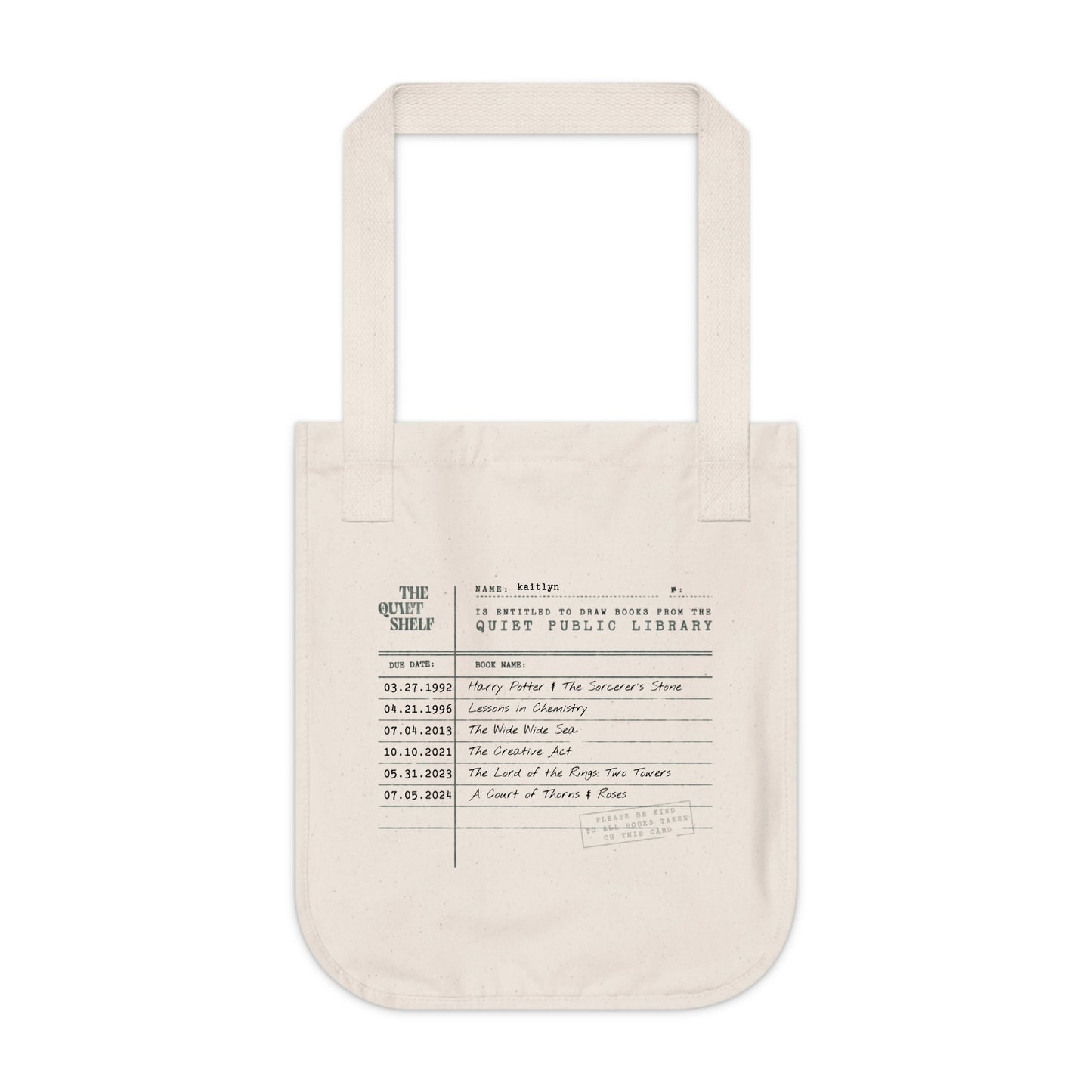 Beige tote bag with printed text on a white background