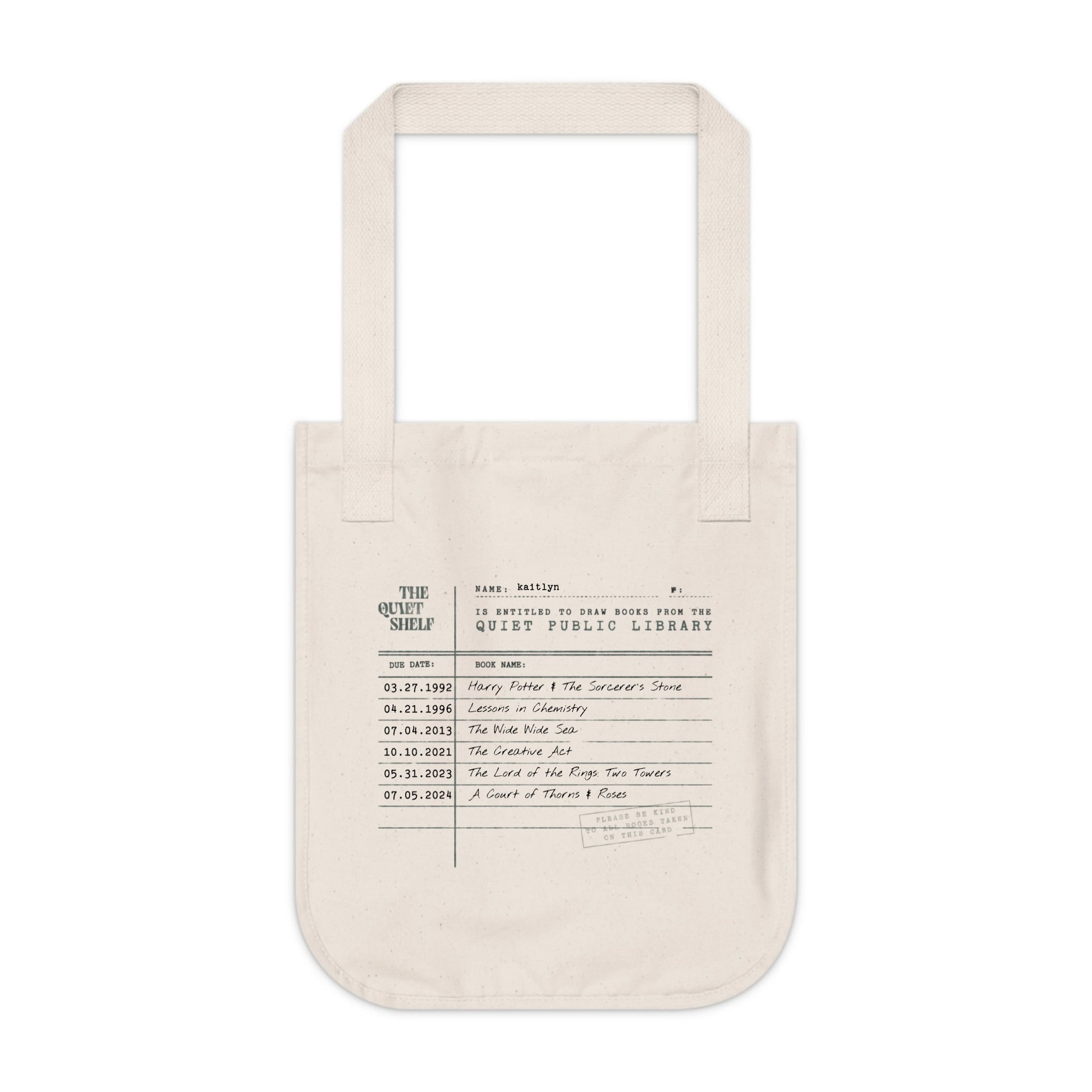 Beige tote bag with printed text on a white background