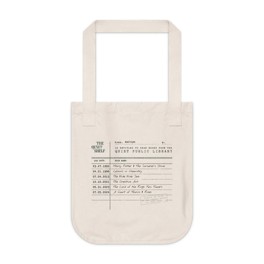 Beige tote bag with printed text on a white background