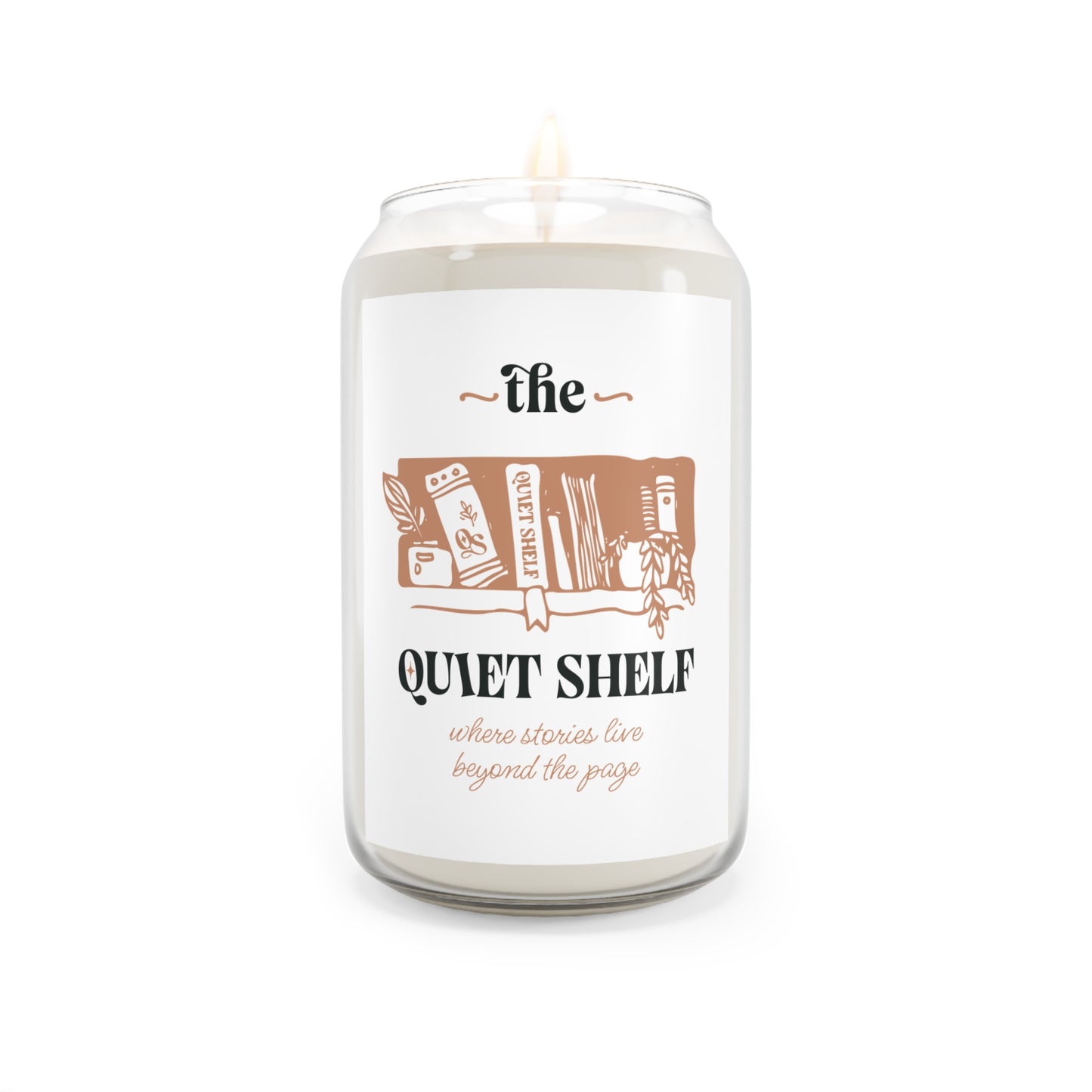A soy candle in a clear glass jar with a minimalist label that features a book and the text 'the QUIET SHELF', with a lit wick, on a white background.